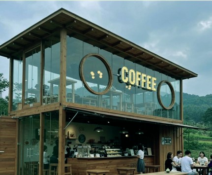 Contemporary two-story wooden glasshouse cafe along the highway