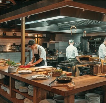 Chefs preparing culinary banquets in a modern stainless steel kitchen